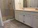 Bathroom featuring double sinks, white cabinets, and a glass-enclosed shower at 4889 Wedgewood Way, Stone Mountain, GA 30088