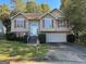 Charming home with a well-manicured front yard and beautiful red shutters at 4889 Wedgewood Way, Stone Mountain, GA 30088