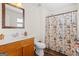 Bathroom featuring wood vanity and a shower-tub with decorative Eiffel Tower shower curtain at 2205 Hyssop Way, Buford, GA 30519