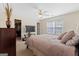 A bright, spacious bedroom featuring a ceiling fan and a large window at 2205 Hyssop Way, Buford, GA 30519