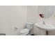 Well-lit half-bathroom featuring a pedestal sink and modern fixtures at 2205 Hyssop Way, Buford, GA 30519