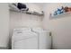 A laundry room with a white washer and dryer, offering convenient laundry amenities at 2205 Hyssop Way, Buford, GA 30519