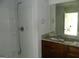 Bathroom featuring a walk-in shower, granite countertops, and wooden cabinets at 7484 Knoll Hollow Rd, Lithonia, GA 30058