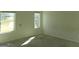 Bright bedroom with large windows providing natural light and neutral carpet flooring at 7484 Knoll Hollow Rd, Lithonia, GA 30058