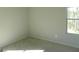 Bright bedroom with plush carpeting and a large window overlooking a wooded area at 7484 Knoll Hollow Rd, Lithonia, GA 30058