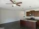 Kitchen area with stainless steel appliances, granite countertops, an island, and dark wood floors at 7484 Knoll Hollow Rd, Lithonia, GA 30058