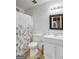 Bathroom featuring toilet, sink, mirror, and shower with a floral curtain and a neutral colored flooring at 912 Shadow Ridge Cir, Stockbridge, GA 30281
