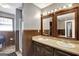 Bathroom featuring double sinks, wooden framed mirrors, neutral counters, and traditional decor with wood paneled walls at 912 Shadow Ridge Cir, Stockbridge, GA 30281
