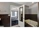 Bathroom view highlighting tub and door into main bedroom, with a partial view of the bathroom's neutral decor and color scheme at 912 Shadow Ridge Cir, Stockbridge, GA 30281