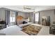 Spacious bedroom with neutral colors, two ceiling fans, and a sliding sofa bed at 912 Shadow Ridge Cir, Stockbridge, GA 30281