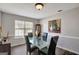 Contemporary dining room with glass table, sleek chairs, and stylish decor at 912 Shadow Ridge Cir, Stockbridge, GA 30281