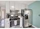 Modern kitchen boasts stainless steel appliances, stylish cabinets, and adjacent access to other rooms at 912 Shadow Ridge Cir, Stockbridge, GA 30281