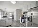 Well-lit kitchen featuring stainless steel appliances, tiled flooring, and white cabinetry at 912 Shadow Ridge Cir, Stockbridge, GA 30281