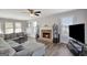 Spacious living room features a brick fireplace, a large sectional, and ample natural light at 912 Shadow Ridge Cir, Stockbridge, GA 30281