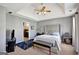 A peaceful main bedroom with tray ceilings, a large bed, and an ensuite bathroom at 912 Shadow Ridge Cir, Stockbridge, GA 30281