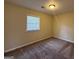 Cozy bedroom with neutral walls, carpet, and a bright window at 2987 Landmark Se Dr, Conyers, GA 30094