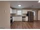 Modern kitchen featuring stainless steel appliances, white cabinets, and a granite countertop at 2987 Landmark Se Dr, Conyers, GA 30094