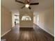 Open-concept living area with hardwood floors, ceiling fan, and a decorative archway at 2987 Landmark Se Dr, Conyers, GA 30094