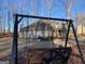 Backyard view of a home from a wooden porch swing at 275 Nutt Dr, Locust Grove, GA 30248