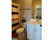 Clean bathroom with toilet, stylish shower curtain, and vanity with white cabinetry at 275 Nutt Dr, Locust Grove, GA 30248