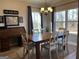 Bright dining area with a large wooden table, decorative chandelier, and natural light at 275 Nutt Dr, Locust Grove, GA 30248