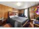 Bedroom with wood paneled walls, and a comfortable bed, creating a relaxing space at 1055 Adrian Sw Cir, Conyers, GA 30094