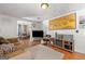Cozy living room with wood floors, comfortable seating, and view into dining room at 1055 Adrian Sw Cir, Conyers, GA 30094