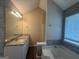 Bathroom featuring a tiled wall, a large mirror, and a vanity with granite countertops at 2795 Oxford Dr, Decatur, GA 30034