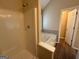 Well-lit bathroom featuring a shower and separate tiled tub at 2795 Oxford Dr, Decatur, GA 30034