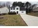 Charming two-story white home with manicured lawn, dark shutters, and an attached garage at 2795 Oxford Dr, Decatur, GA 30034