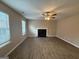 Bright living room featuring hardwood floors, fireplace, and large windows letting in natural light at 2795 Oxford Dr, Decatur, GA 30034