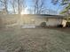 The backyard features a small patio, a detached carport, and lots of trees at 1380 Margarette Dr, Decatur, GA 30035