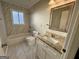 Classic bathroom features a vanity with granite countertop and tiled shower at 1380 Margarette Dr, Decatur, GA 30035