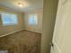 This cozy bedroom has neutral walls, plush carpet, and two windows for lots of natural light at 1380 Margarette Dr, Decatur, GA 30035
