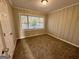 Comfortable bedroom with carpet flooring, natural light and classic paneled walls at 1380 Margarette Dr, Decatur, GA 30035