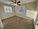 This cozy bedroom has a ceiling fan, neutral walls, plush carpet, and two windows for lots of natural light at 1380 Margarette Dr, Decatur, GA 30035