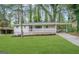 Charming brick home with a covered porch, carport, and well-maintained lawn at 1380 Margarette Dr, Decatur, GA 30035
