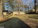 Traditional home with a large front yard, carport, and mature trees at 1380 Margarette Dr, Decatur, GA 30035