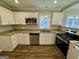 Modern kitchen with stainless steel appliances, granite counters, and bright white cabinets at 1380 Margarette Dr, Decatur, GA 30035
