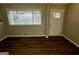 Cozy living room features beautiful wood floors, neutral walls, and a view to the outdoors at 1380 Margarette Dr, Decatur, GA 30035