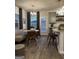 Bright kitchen with gray cabinets, stainless steel appliances, granite countertops, a breakfast bar, and natural light at 235 Ivey Ter # 40, Temple, GA 30179