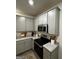 Bright kitchen with gray cabinets, stainless steel appliances, granite countertops, and a modern oven at 235 Ivey Ter # 40, Temple, GA 30179