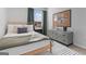 Cozy bedroom featuring stylish decor, natural wood bed frame, and a cork board above the dresser at 237 Ivey Ter # 41, Temple, GA 30179