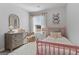 Bright bedroom with a pink spindle bed, butterfly artwork, and a neutral dresser with a gold mirror at 237 Ivey Ter # 41, Temple, GA 30179