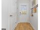Inviting entryway featuring light-colored wood floors, a white door with window, and convenient coat hooks at 237 Ivey Ter # 41, Temple, GA 30179