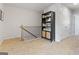 Upstairs hallway featuring neutral walls, carpet, a black bookshelf, and white trim at 237 Ivey Ter # 41, Temple, GA 30179