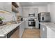 Contemporary kitchen with stainless steel appliances, gray cabinets, and beautiful granite countertops at 237 Ivey Ter # 41, Temple, GA 30179