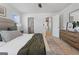This main bedroom features neutral tones, a green throw blanket, and access to the ensuite bathroom at 237 Ivey Ter # 41, Temple, GA 30179