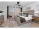 The main bedroom features a ceiling fan, a large bed, and a sitting area near a window at 237 Ivey Ter # 41, Temple, GA 30179