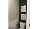 Powder room with olive green accent wall and minimalist black and white artwork at 237 Ivey Ter # 41, Temple, GA 30179